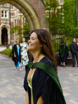 Maddie  waits her turn for a snap under 'the' arch.